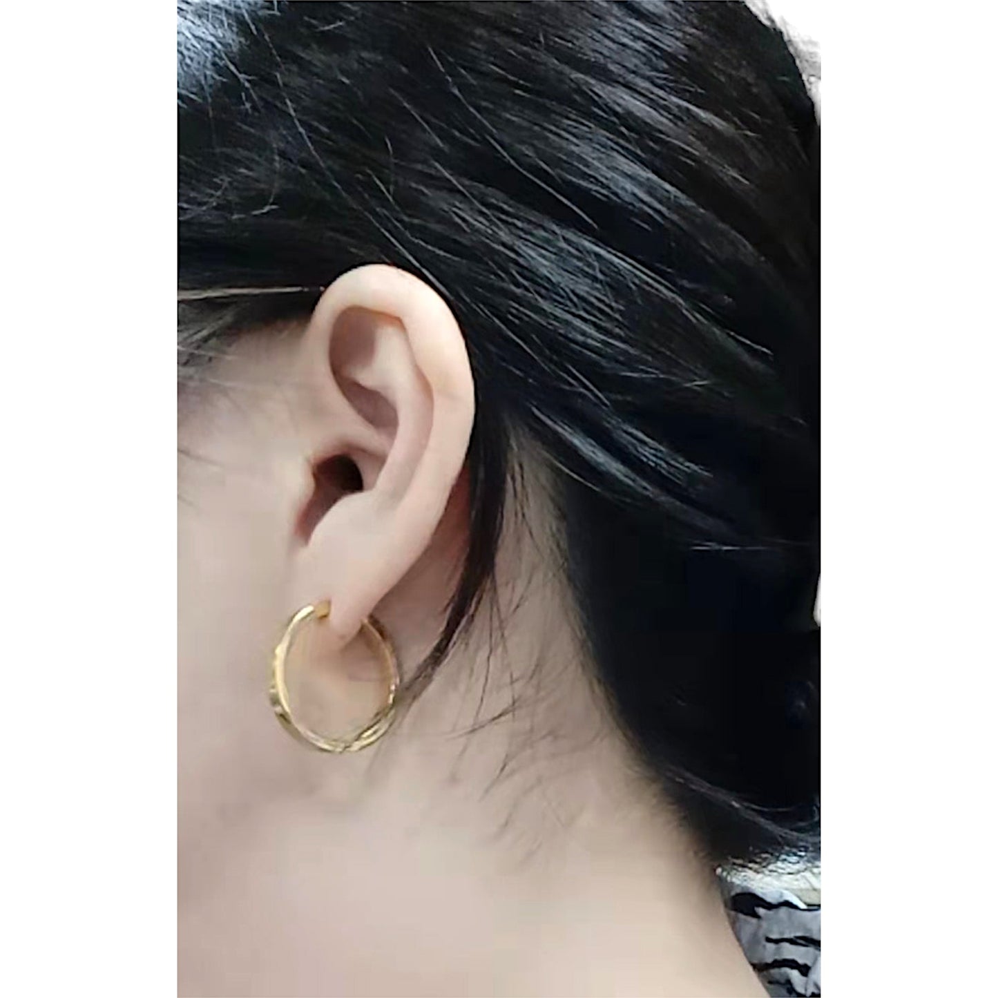 Gold Titanium Hoop earrings with shiny gold finish 24mm. On a white woman with black hair made 100% from titanium.
