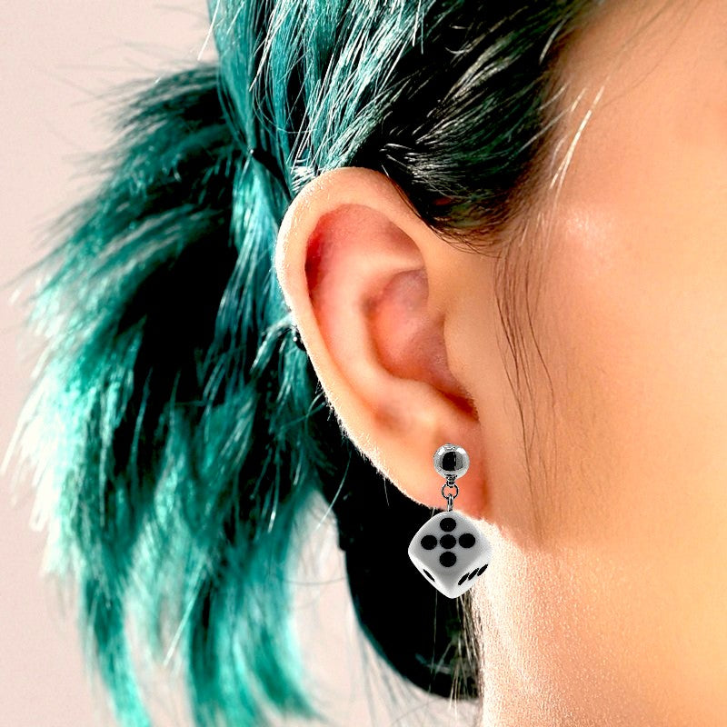 Dice earrings with a titanium magnetic stud on a white woman
