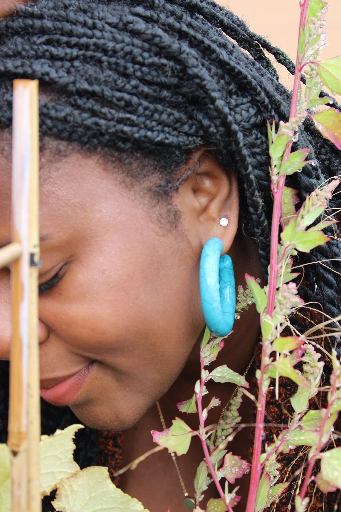 Large Sapphire Hoops on a black woman. posts are made from titanium.