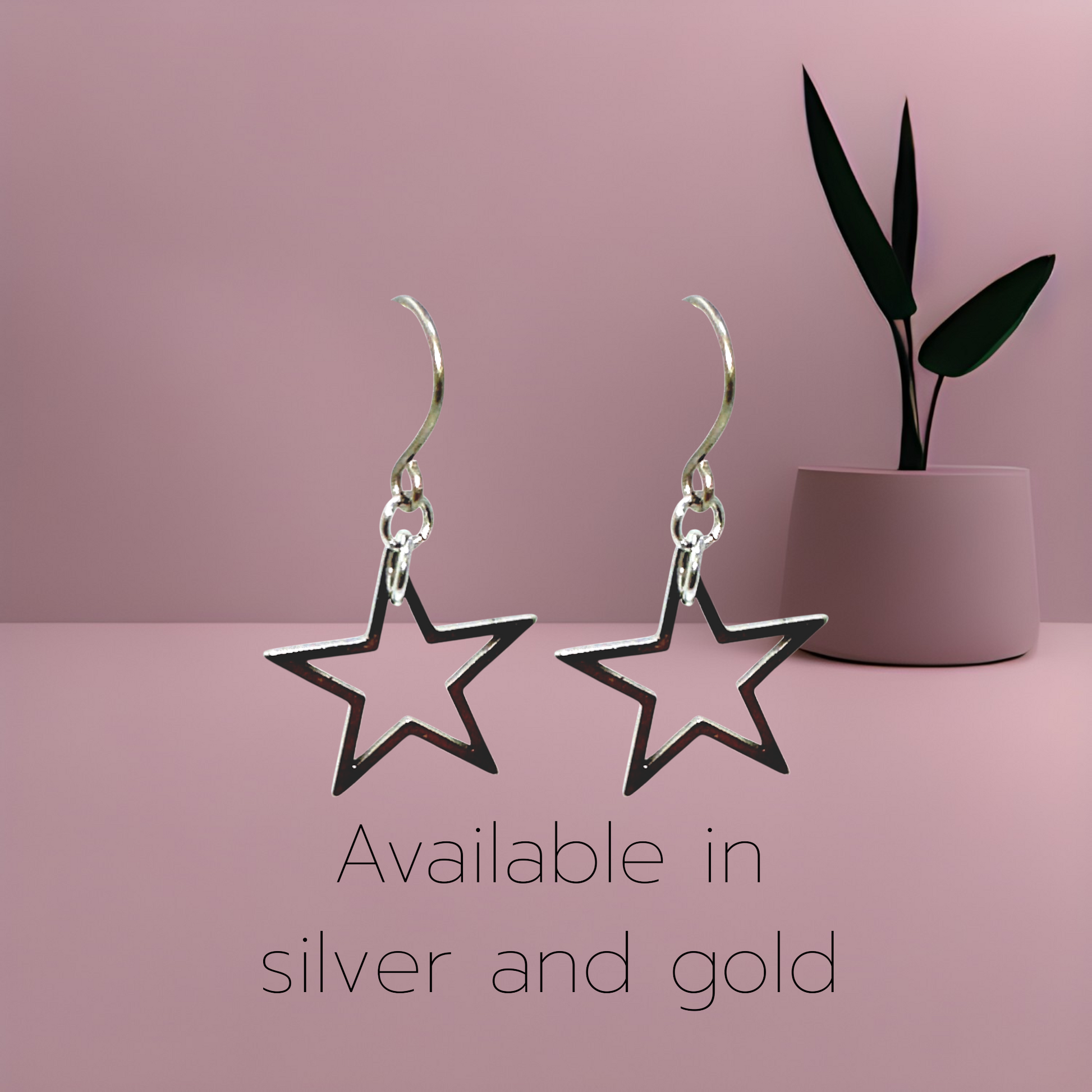 Silver and gold Star Titanium Earrings with a titanium hook on a pink background
