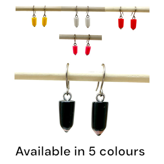 Pencil earrings with a titanium hook on a white background. lettering