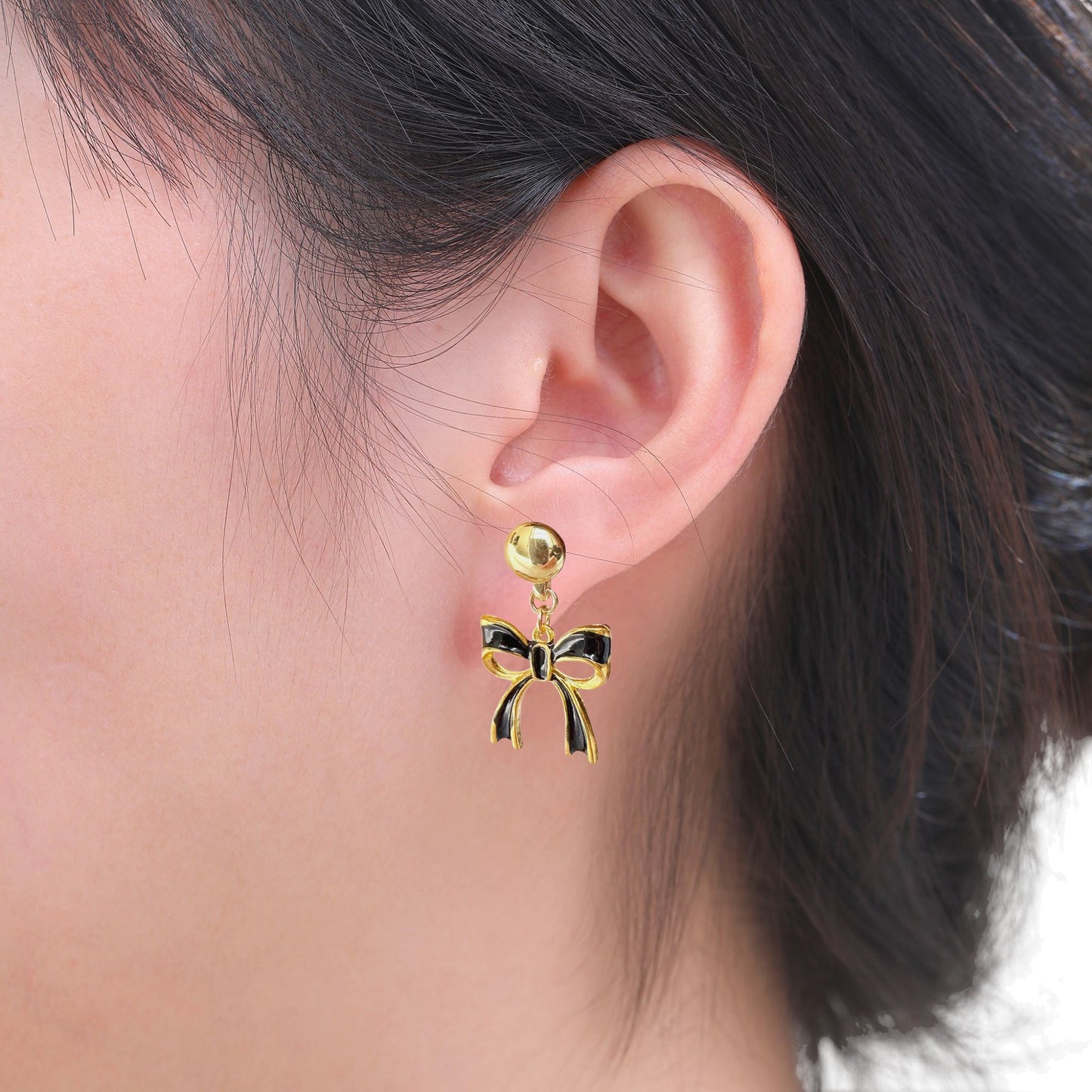Titanium Black Bow earrings. Detachable earrings for a truly hypoallergenic jewellery on a white young woman