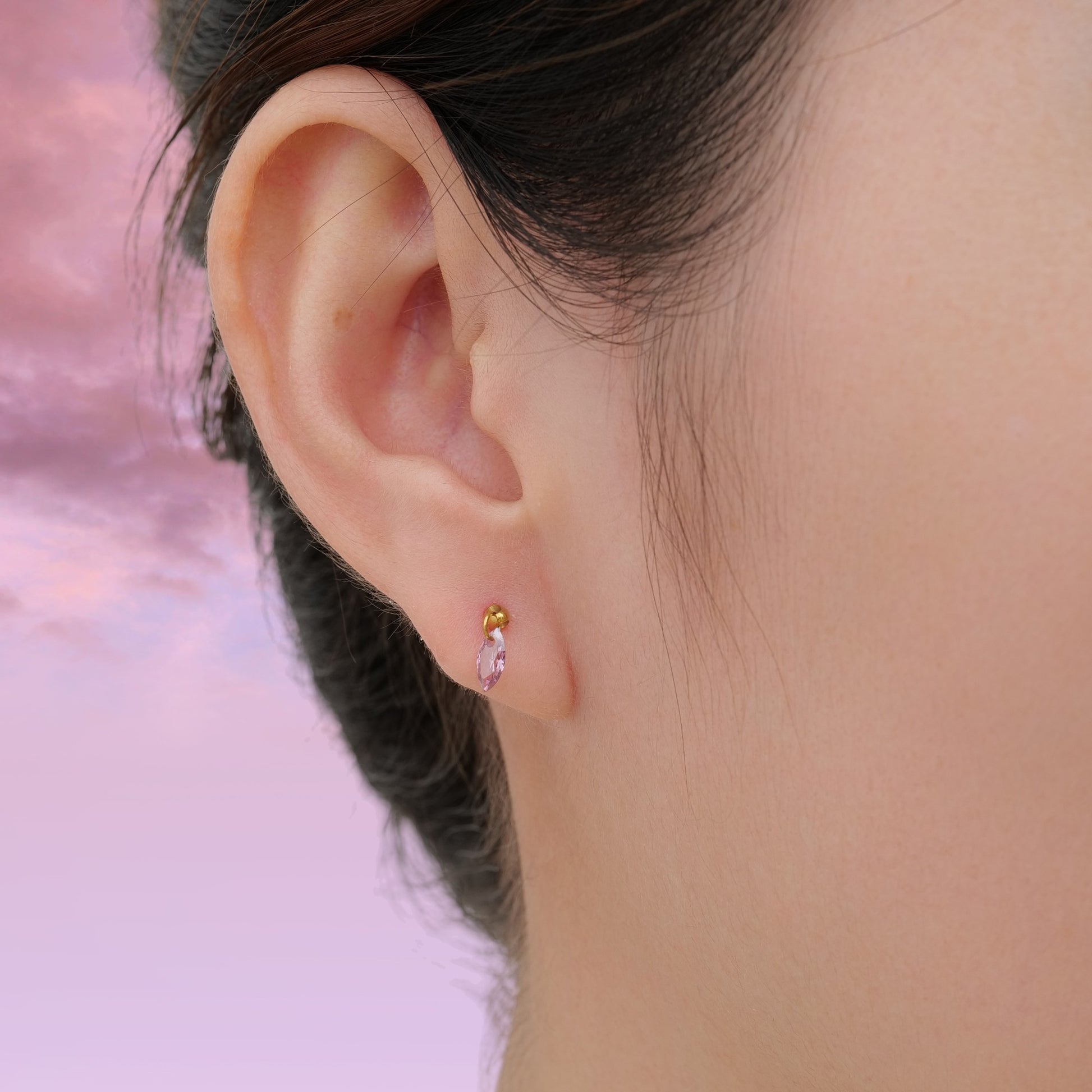 Hanging Marquise Pink flat back titanium earrings with gemstone on a woman