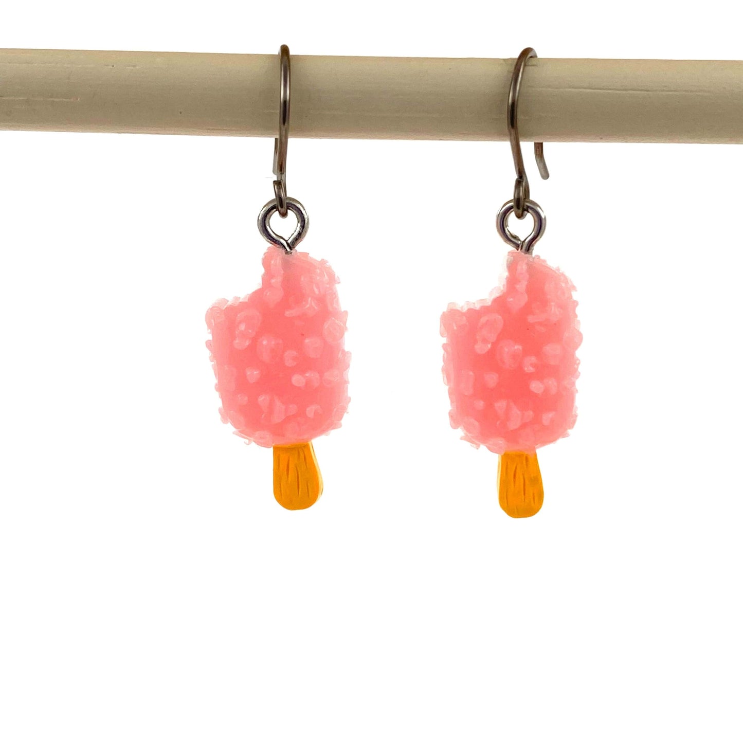 Popsicle earrings with a titanium hook on a white background. pink