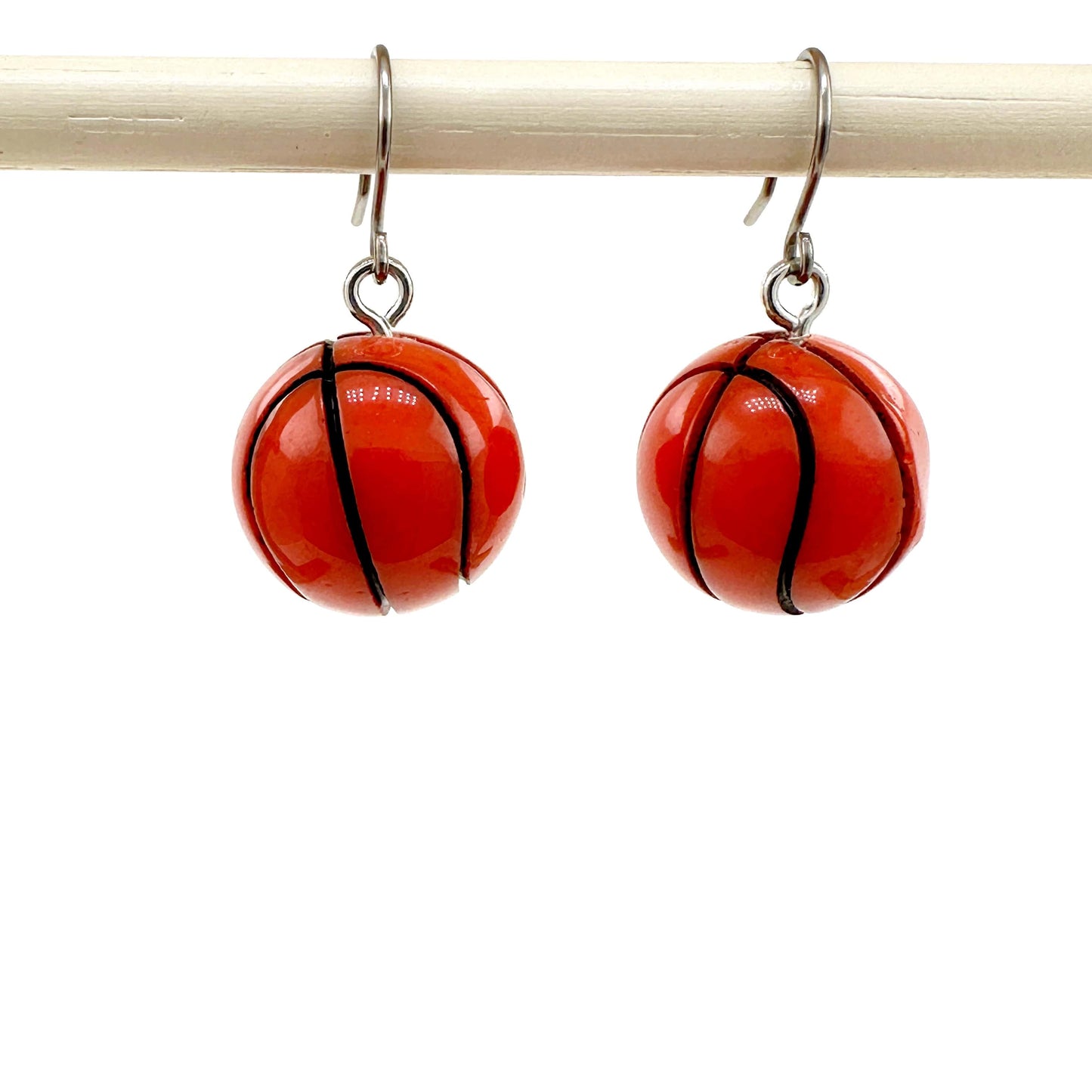 Basketball drop earrings with titanium hook on a white background