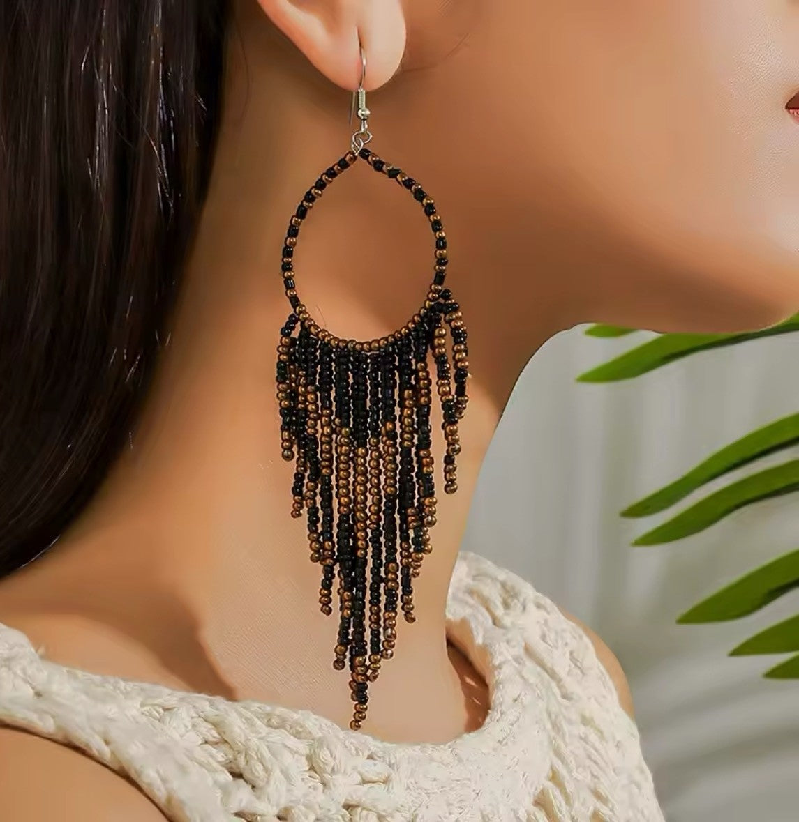 Titanium Handcrafted beadwork hoop earrings. Brown and black beads traditional native inspired on a woman