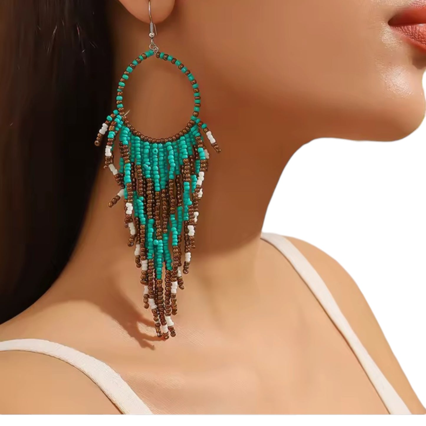 Titanium Handcrafted beadwork hoop earrings. turquoise brown white beads traditional native inspired on a woman