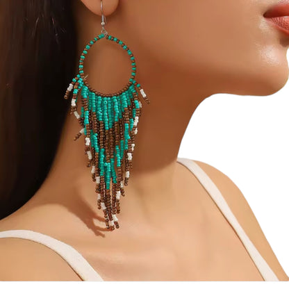 Titanium Handcrafted beadwork hoop earrings. turquoise brown white beads traditional native inspired on a woman