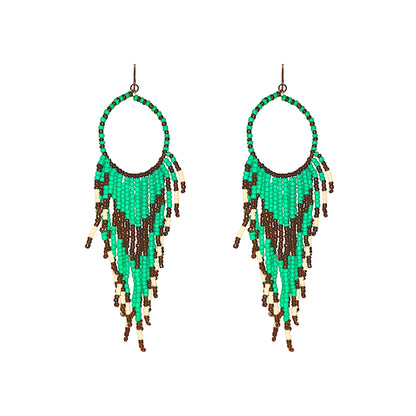 Titanium Handcrafted beadwork hoop earrings. turquoise brown white beads traditional native inspired on a white background