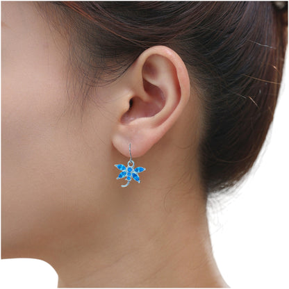 Bejewelled blue Dragonfly earrings with titanium hook on a white young woman