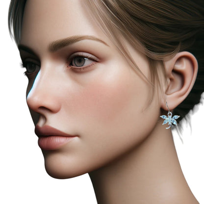 Bejewelled clear Dragonfly earrings with titanium hook on a white young woman.