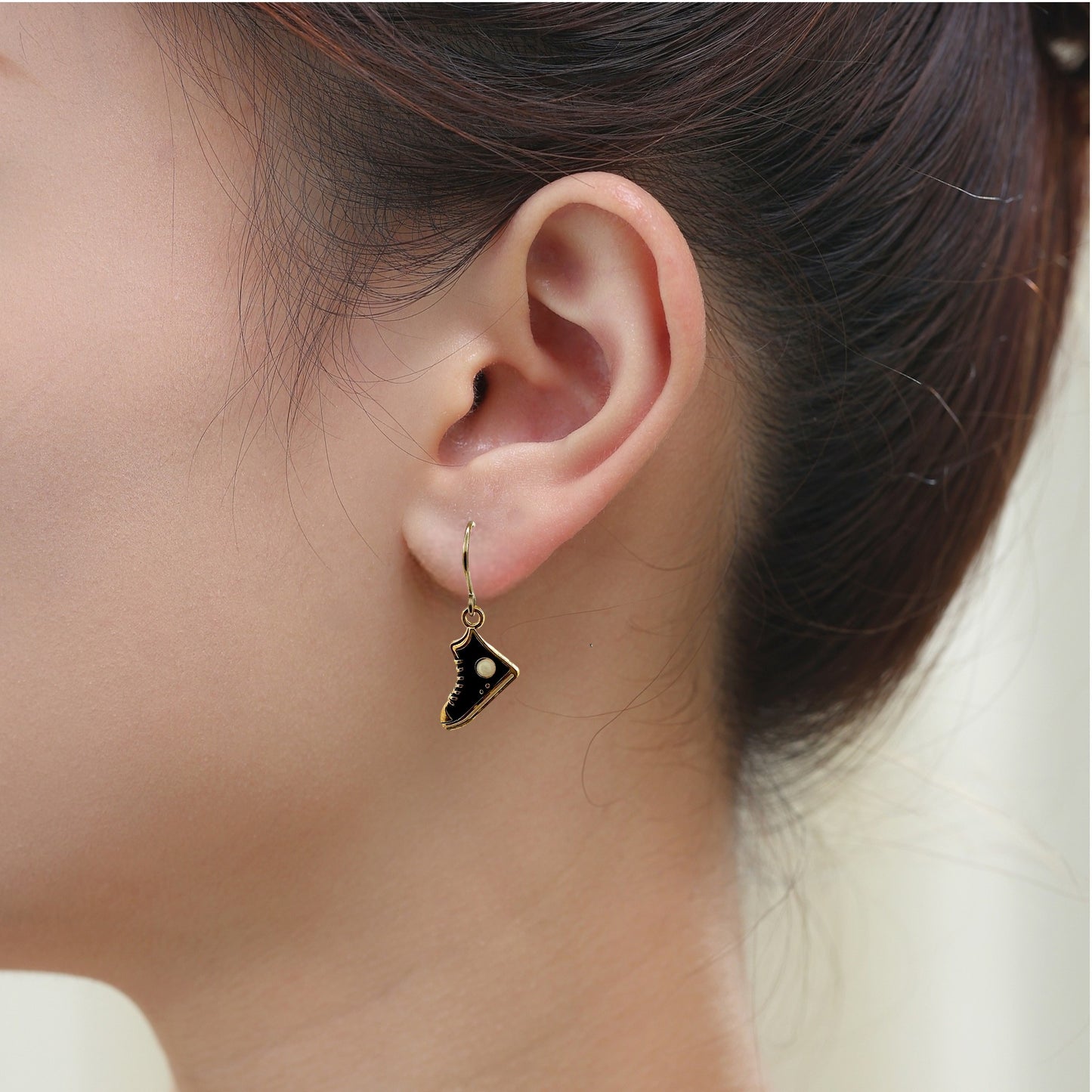 Running Shoe Charm Drop Earrings with a titanium hook on a white young woman. black