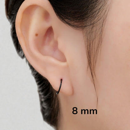 Black anodzed titanium 8 mm hoop earrings sized on a woman