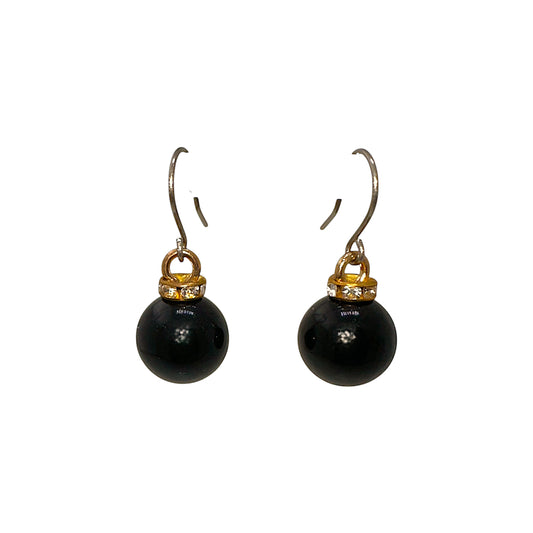 Black pearl earrings with a titanium hook on a white background