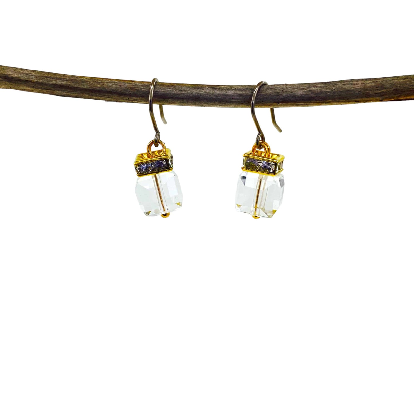 Crystal Clutch earrings with titanium hooks. A flashing crystal with a gold on a branch