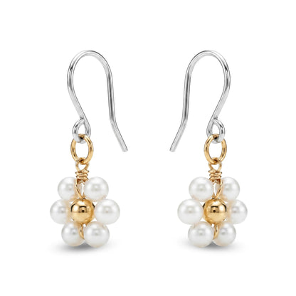 Pair of titanium earrings with pearls and gold accents on a white background