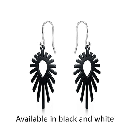 Black titanium shine earrings on a white background with text 'Available in black and white'.