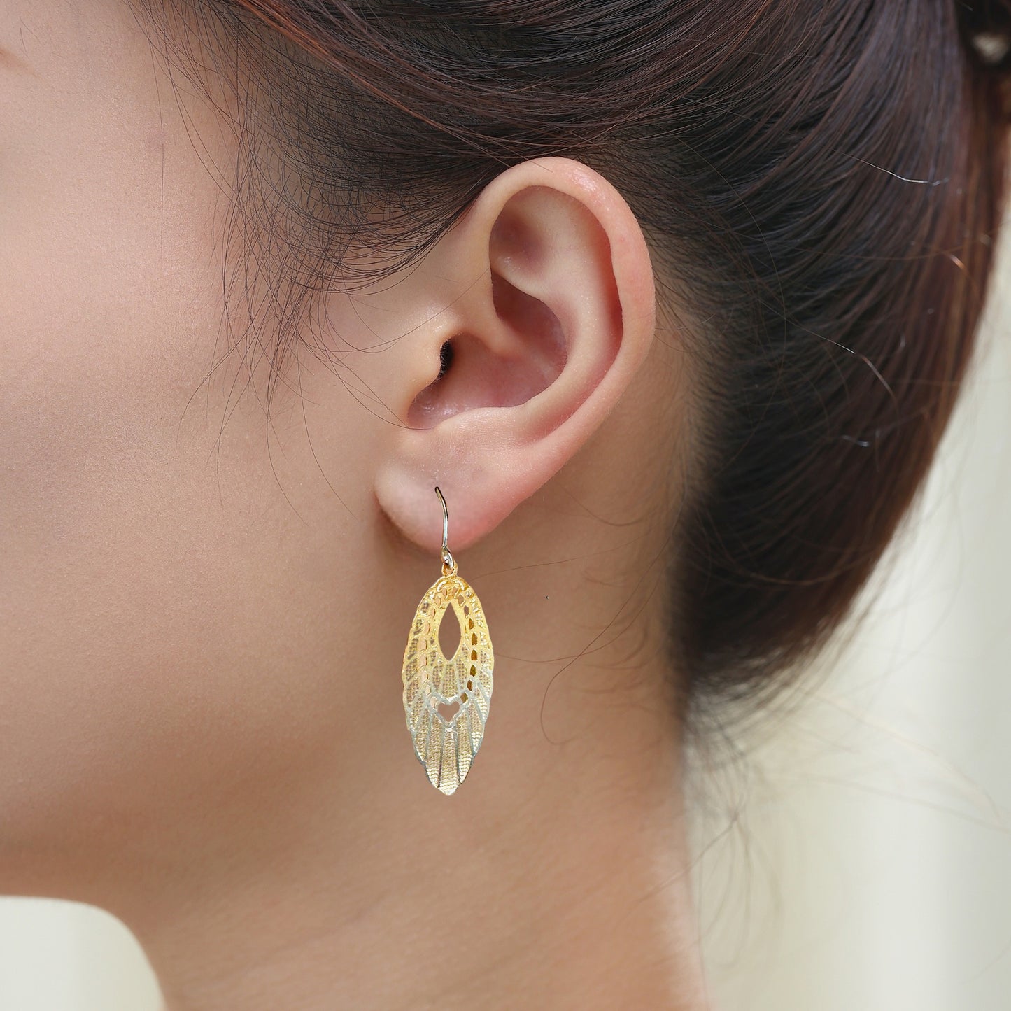 Titanium Gold Pendant Hypoallergenic earrings on a white woman