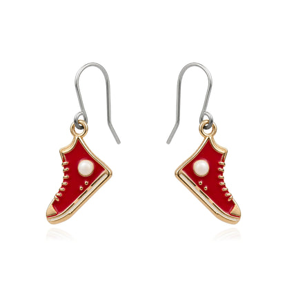A pair of dangling earrings shaped like red high-top sneakers with gold-tone outlines, white pearl-like eyelets, and titanium fishhook wires, shown on a plain white background.