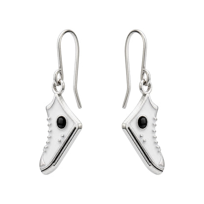 A pair of titanium drop earrings shaped like miniature high-top sneakers, featuring a polished silver finish, a small black oval stone on the side, and titanium ear wires.