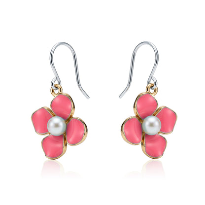 Forget-Me-Not Charm earrings in rose pink with a pearl in the center and a titanium hook on a white background
