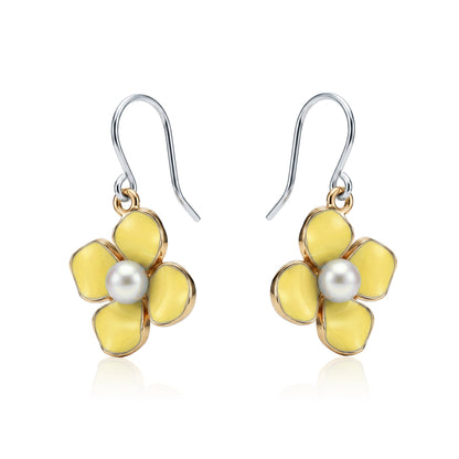 Forget-Me-Not Charm earrings in yellow with a pearl in the center and a titanium hook on a white background