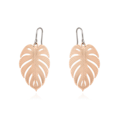 A pair of leaf-shaped drop earrings with a gold finish and titanium hooks, displayed on a clean white background.