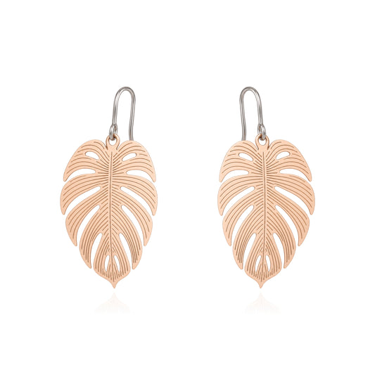 A pair of leaf-shaped drop earrings with a gold finish and titanium hooks, displayed on a clean white background.
