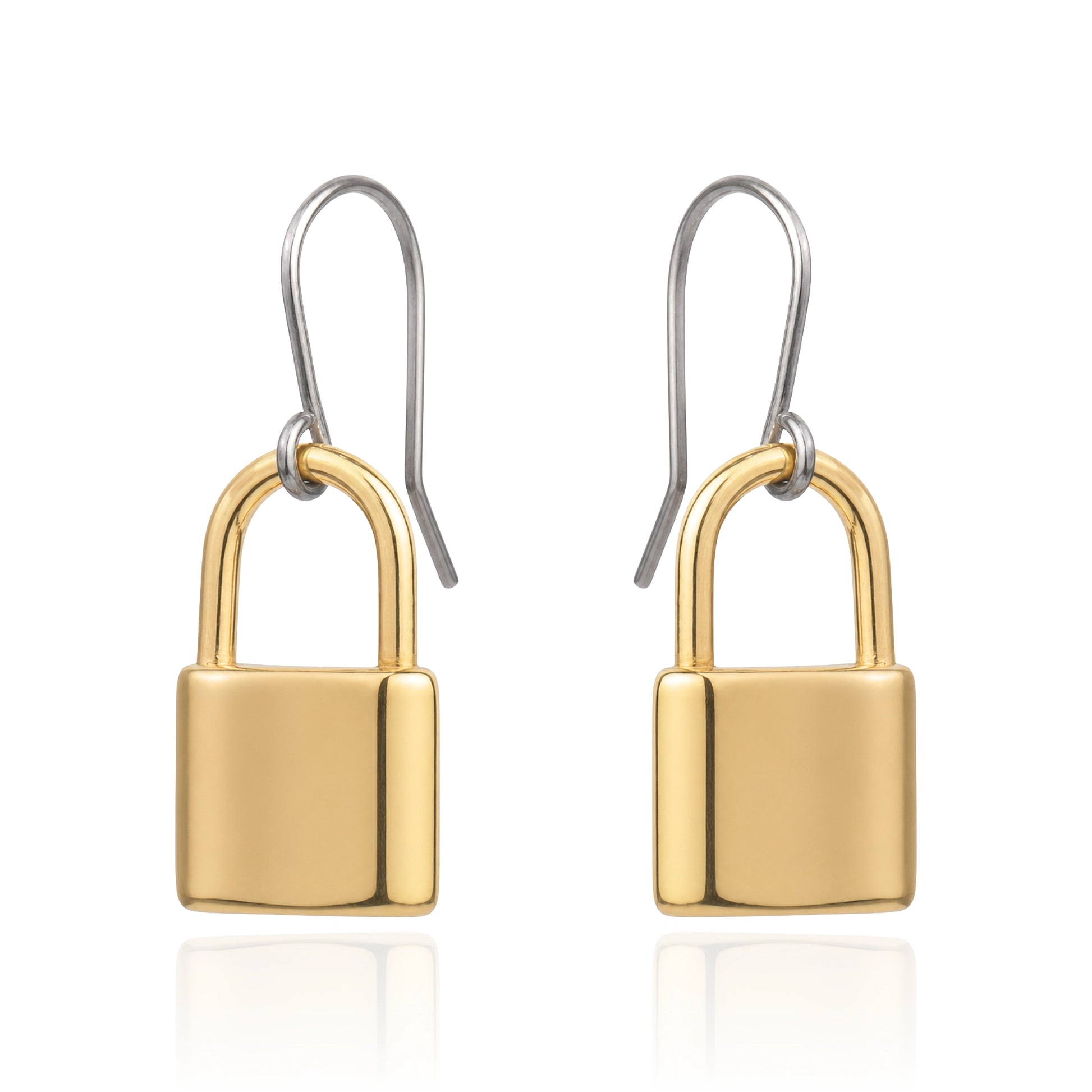 A pair of drop earrings shaped like small padlocks, with polished yellow-gold and titanium hook wires above, shown on a clean white background with a faint reflection below.