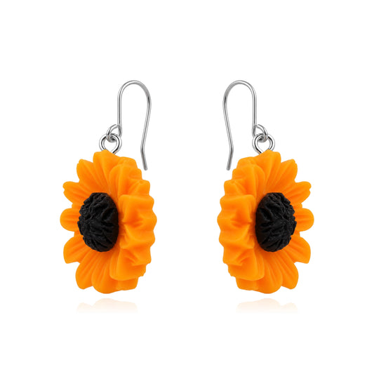 A pair of titanium dangling flower earrings shaped like bright orange sunflowers with textured black centers and titanium fishhook wires, shown on a plain white background.