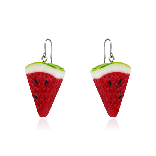 A pair of watermelon slice drop earrings with red bodies, white rinds, green edges, and small black seeds on titanium hooks, shown on a white background.