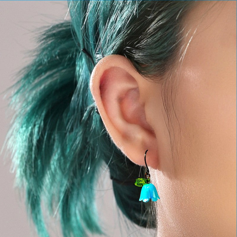 Blue Bell flower titanium earrings on a woman with green hair