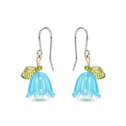 Pair of titanium blue flower-shaped earrings with green leaves on a white background