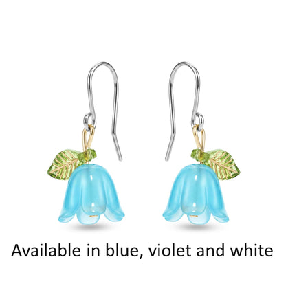 Pair of blue bell flower earrings with and green leaves in 3 colours on a white background