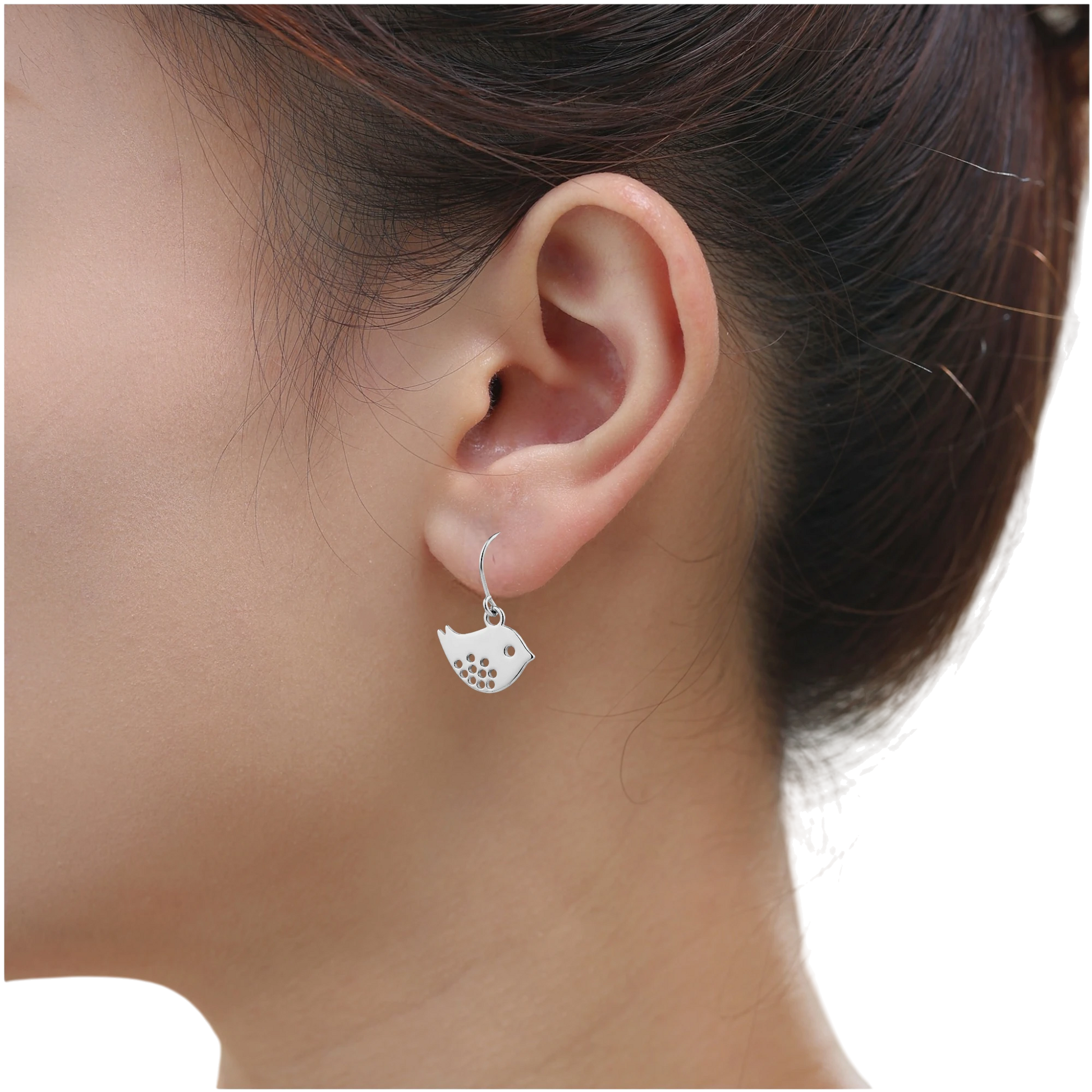 Songbird Charm earrings with a titanium hook on a white young woman. silver bird
