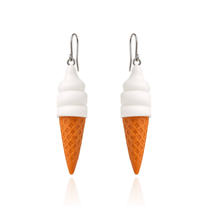 A pair of dangling earrings shaped like ice cream cones, with white swirls representing soft serve and an orange waffle-cone base, hanging from titanium fishhook ear wires on a white background.