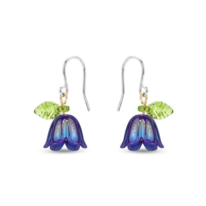 Pair of titanium floral earrings with purple and green details on a white background
