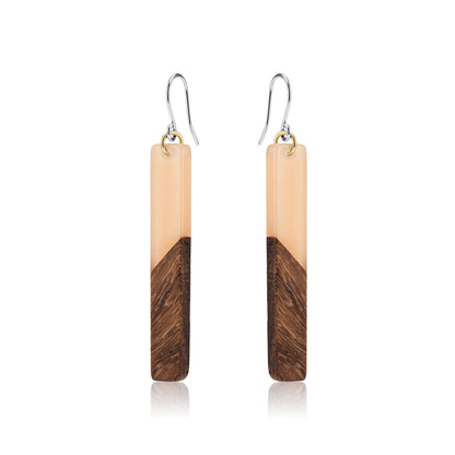 Translucent wood earrings with titanium hook on a white background 
