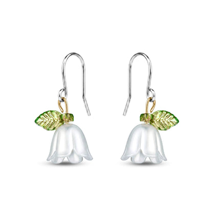 Titanium Floral earrings with white flower and green leaves on a white background
