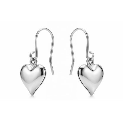 Silver heart earrings with a titanium hook on a white background