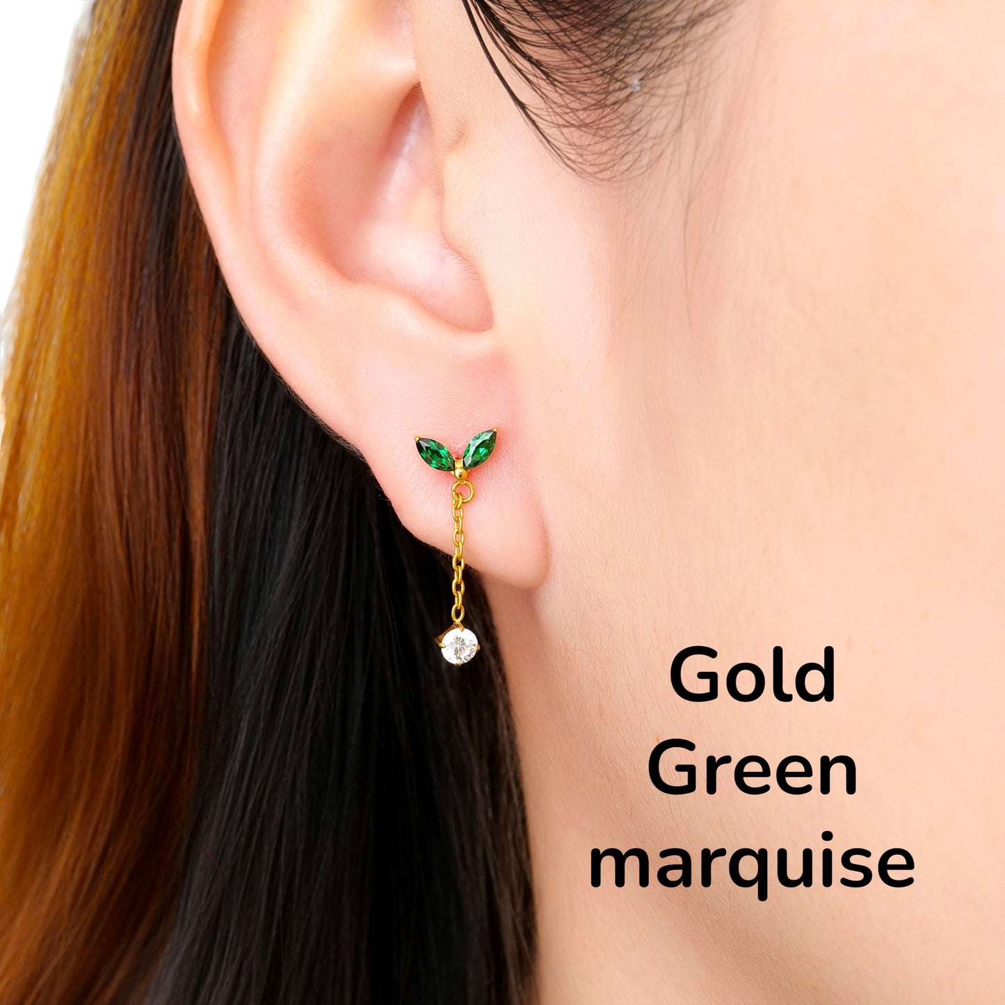 Close-up of an ear wearing a gold green leaf-shaped titanium flat back earring on a woman