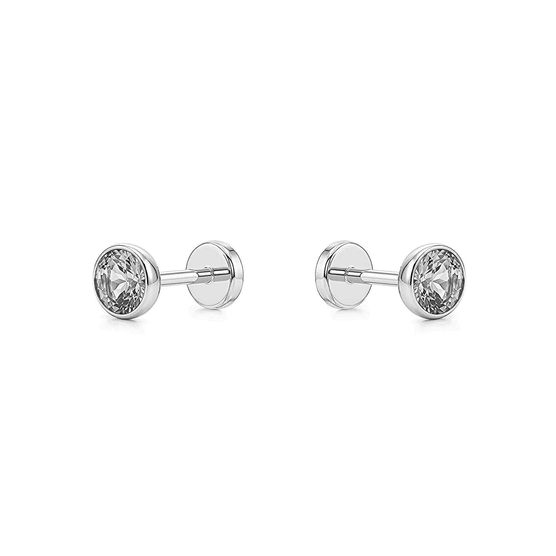 Pair of tianium flat back stud earrings with clear gemstones on a white background