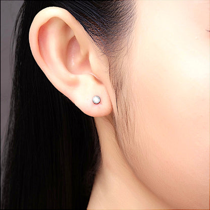 Titanium sunburst flat back stud earring on a white woman