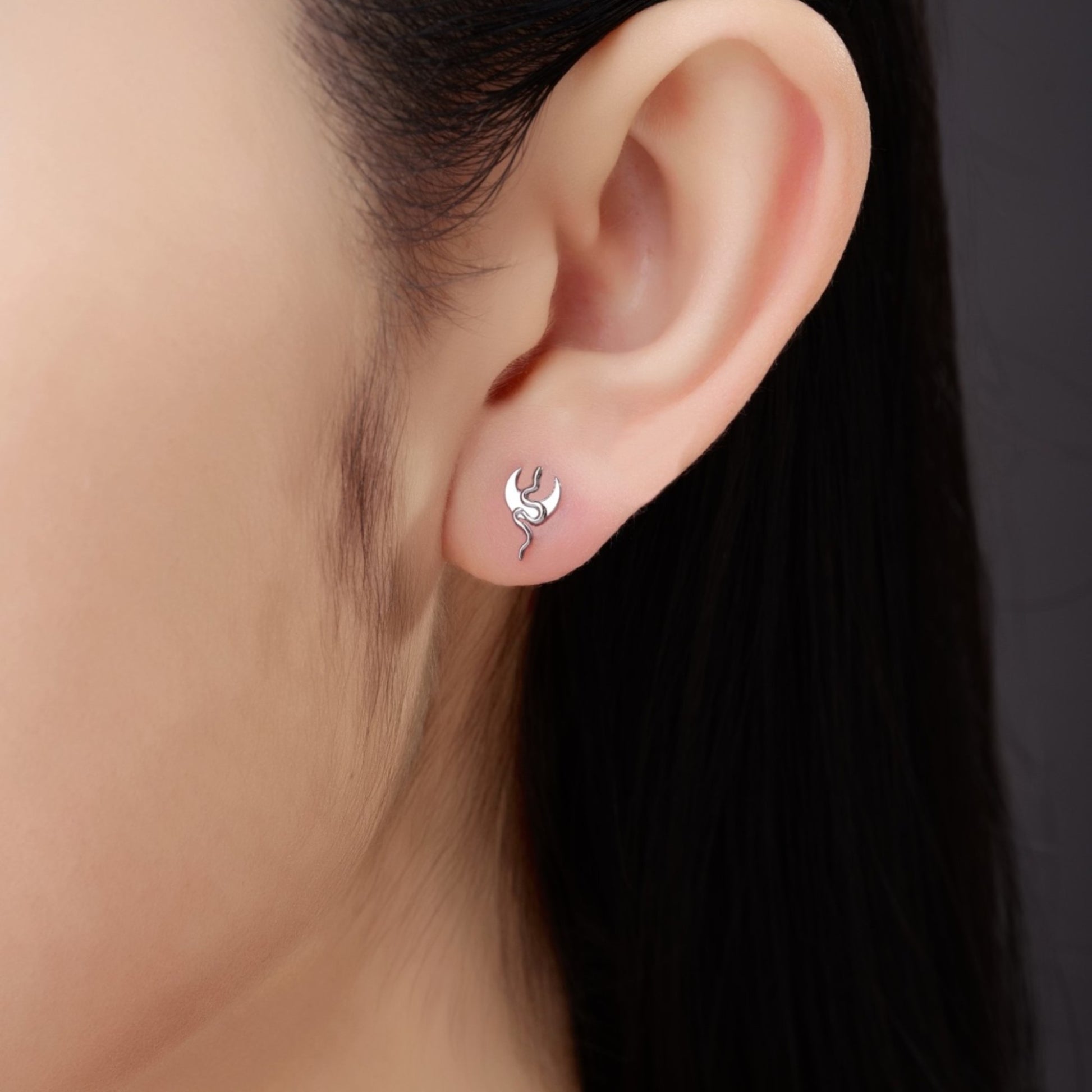 Titanium moon snake flat back threadless stud on a white woman