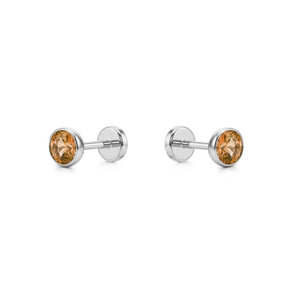 Pair of titanium stud earrings with Champagne gemstones on a white background