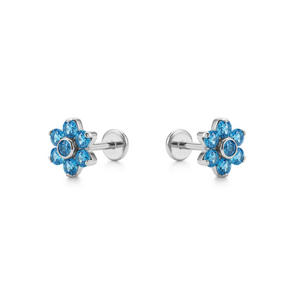 Pair of titanium flat back push in blue flower-shaped earrings on a white background