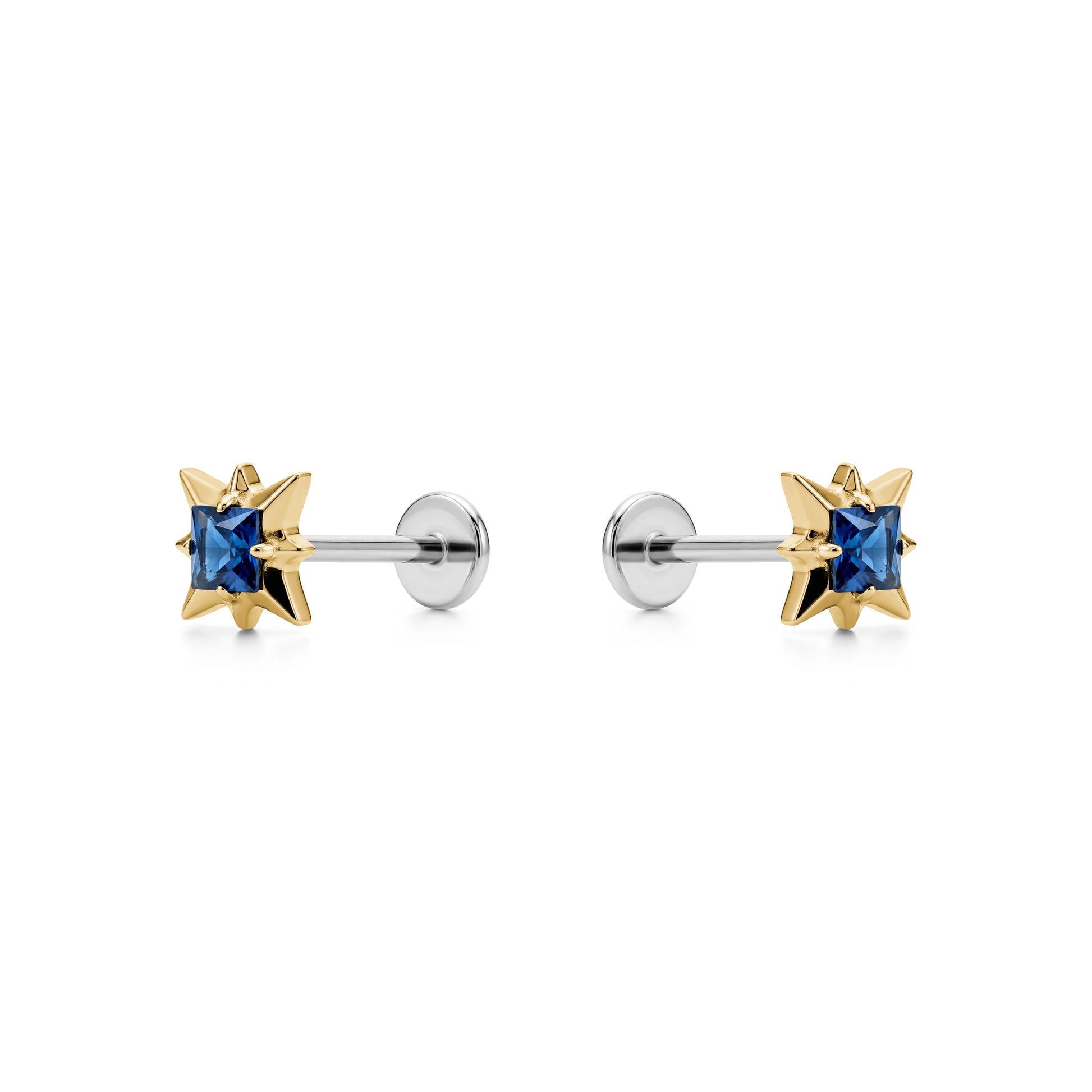 Star-shaped titanium flat back earrings with blue gemstones and gold accents on a white background