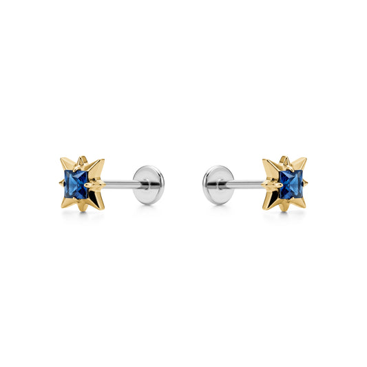 Star-shaped titanium flat back earrings with blue gemstones and gold accents on a white background