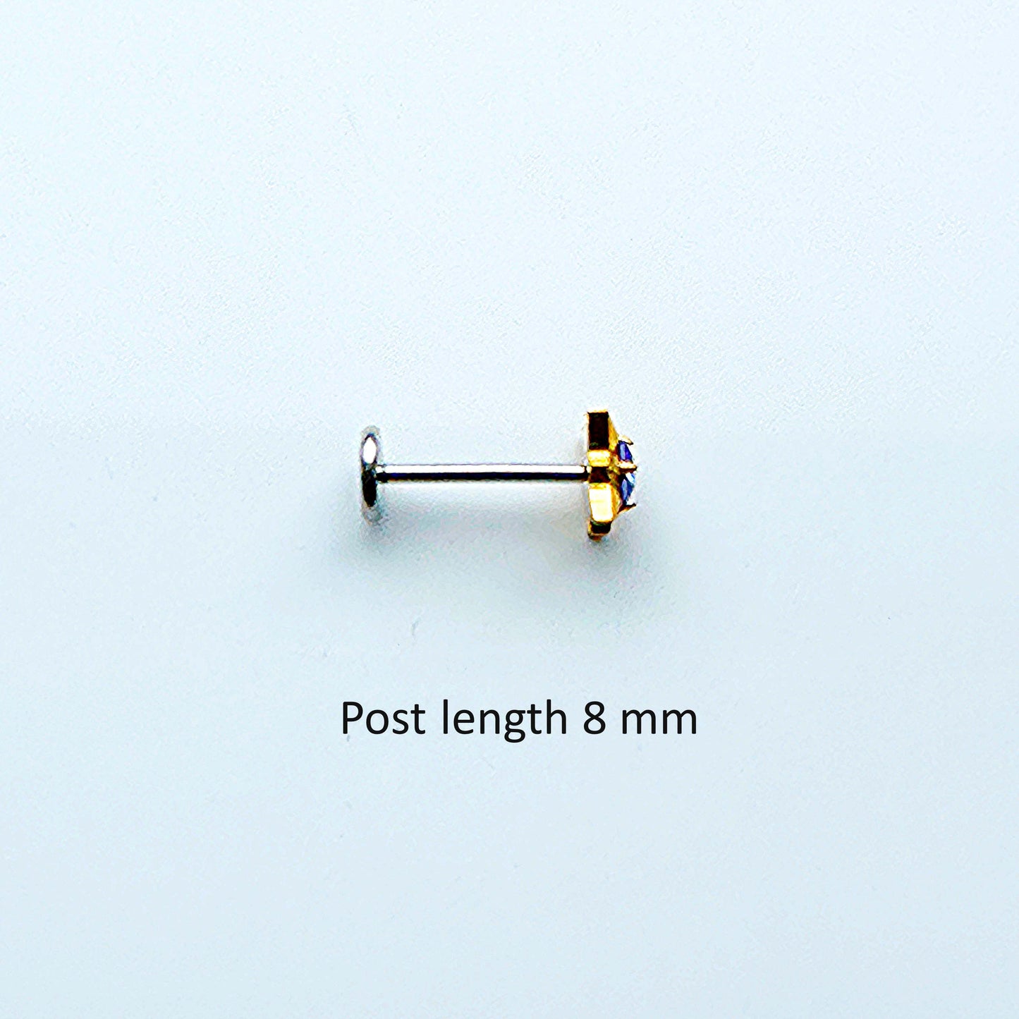 Single titanium gold gem earring on a post 8 mm with a light white background