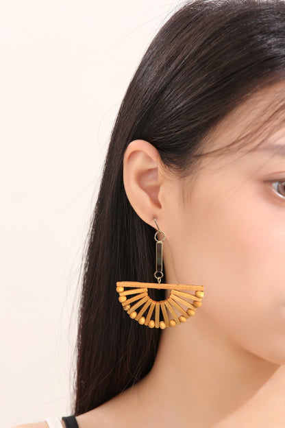 Fan bohemia style wood earrings with a titanium hook on a white young woman